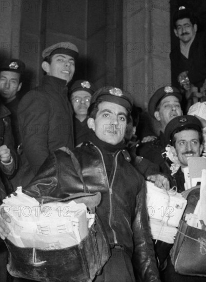 Postmen leave for mail delivery. 1956