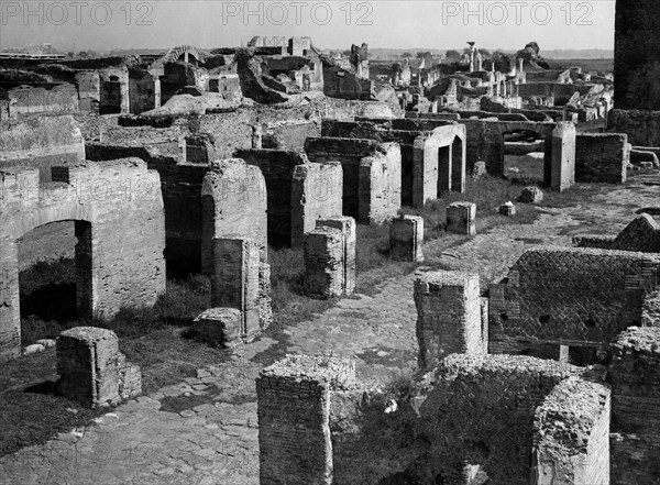 Lazio. street at the capitolium a ostia antica. 1930