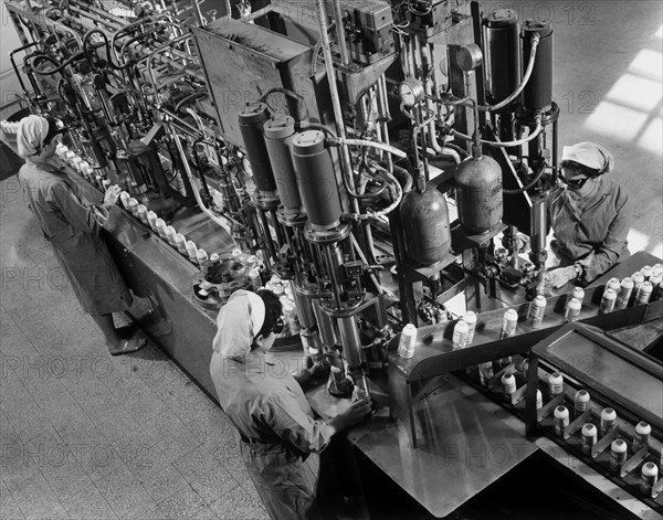 Italy. Lazio. loading line for insecticide cans. 1970