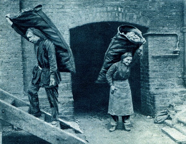 Carrying sack of coke in a London gaswork.