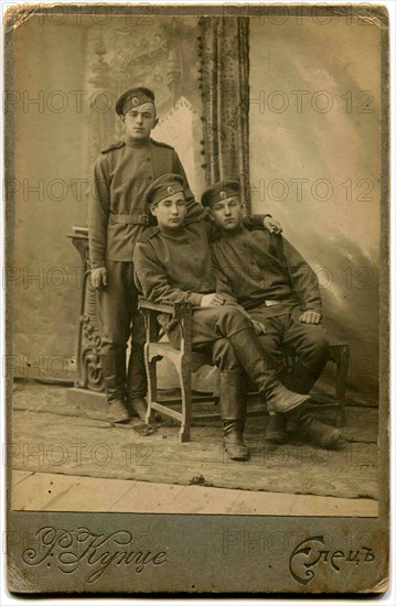 Three soldiers in field uniform.