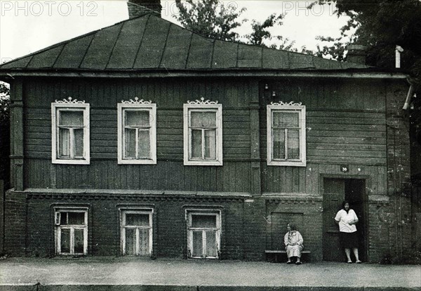 Elderly women near the old house.