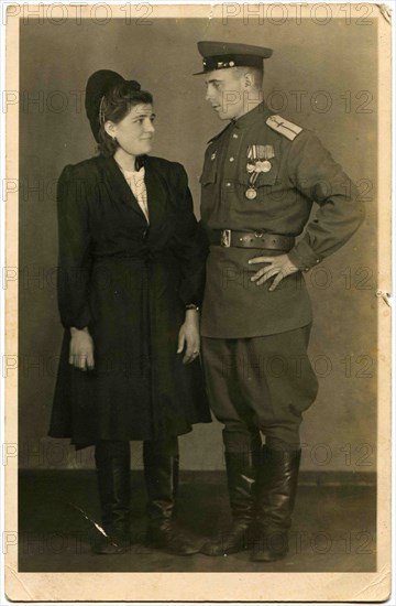 A military pilot who was awarded the Order of the Red Banner, and three medals and a young woman.