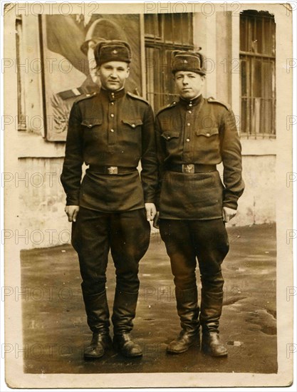 Two Soviet soldiers against the barracks.