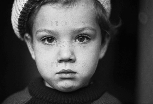 Liittle boy in a sweater and beret.