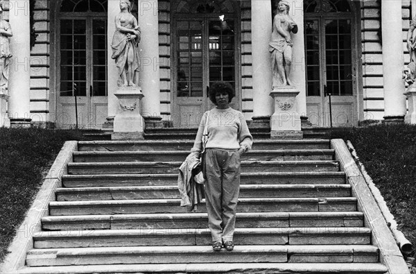 Young woman on the steps of the royal palace at Peterhof.