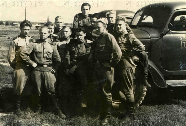 Soviet soldiers against the truck.