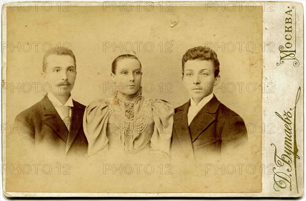An antique photo shows two young men and young woman, the end of 19 - early 20century. Russian text: Butaev (photo); Moscow.