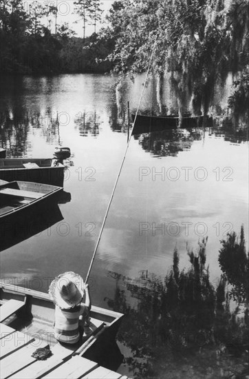 A boy fishing in the scott creek river.