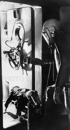 A dog and an astronaut enter a pressure chamber for training.