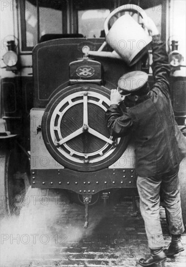 Overheated Engine, A Man Pours Water Into The Radiator.