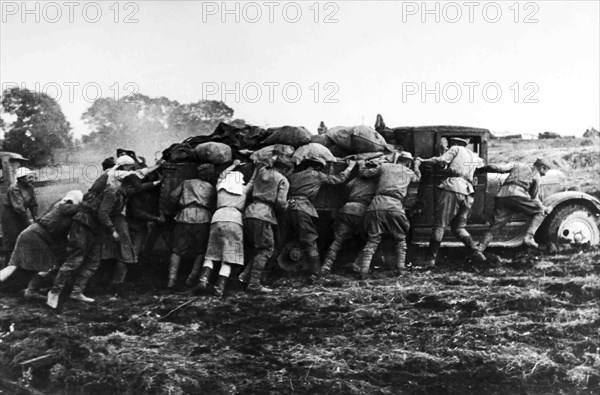 Farmers Help Soldiers Pushing A Truck Loaded In The Russian Steppe.