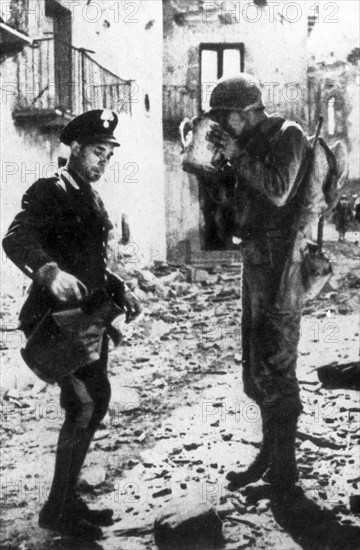 A Carabiniere Gives Water To A U.S. Military.