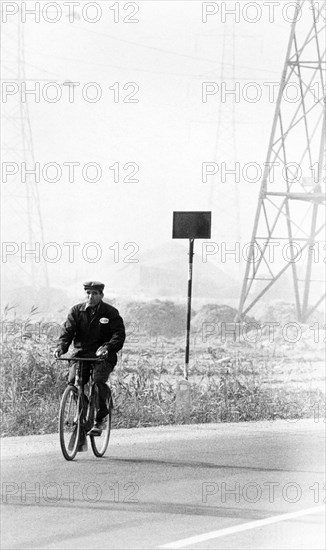 Italy, Lombardy, worker cycling