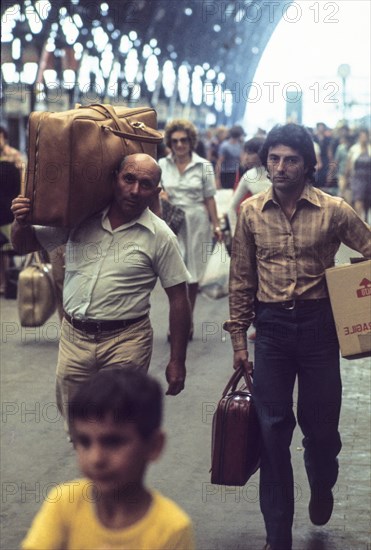 Central station of milan, passengers with baggages, 70's