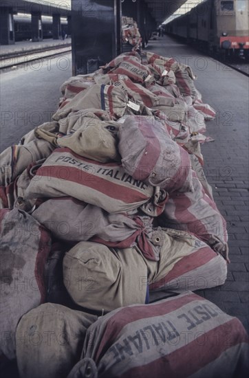 Sacks of poste italiane in railway station, milan, italy, 70's