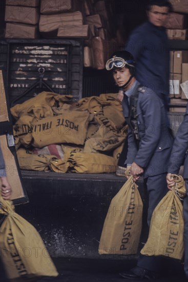 Sacks of poste italiane in railway station, milan, italy, 70's