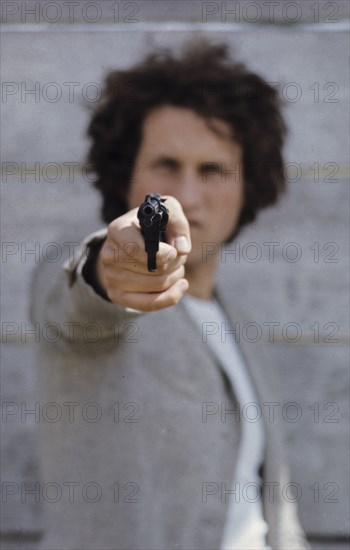 Man with gun, 70's