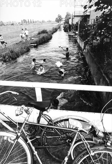 Little boys enjoing in a canal, 70's