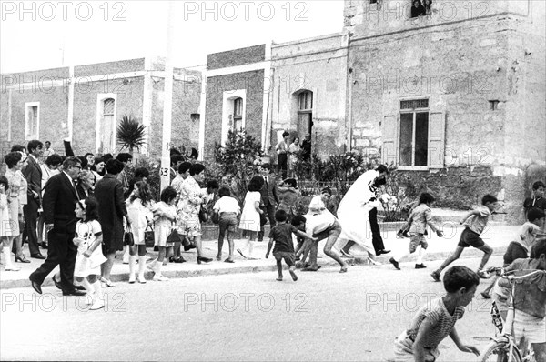 Children collecting candy just launched at the bride, 60's