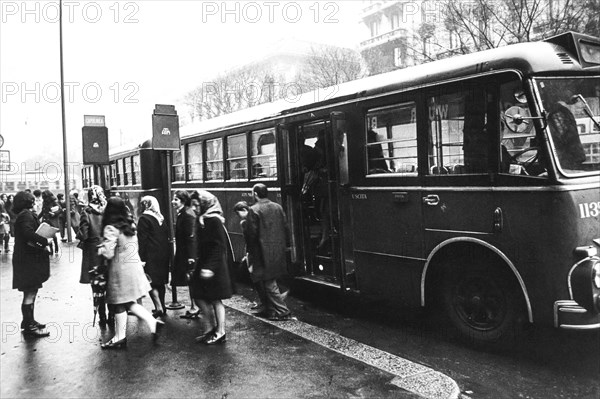 Commuters at bus stop, milan, 60's