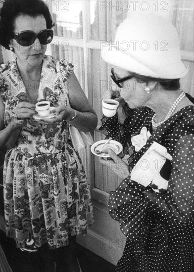 Two women drinking a cup of coffee, 60's