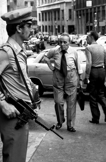 Policeman with a handgun in a street of naples, italy, 80's