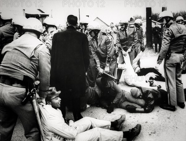 Troopers drag demonstrators to prison buses after about 60 persons laid down in the street to block a school bus from going to the all-negro social circle training school, georgia, 1968