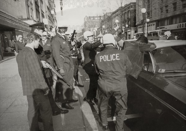 Suspect two black people looters are serched by police in downton washington, 1968