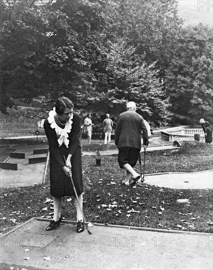 Woman Playing Miniature Golf