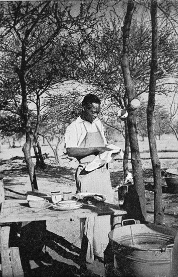 The kitchen boy washing dishes on a German farm