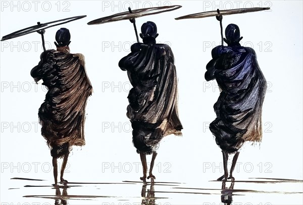 three monks with parasol