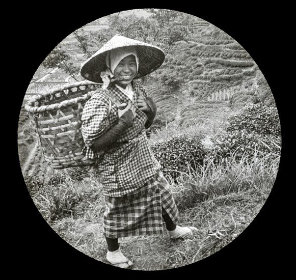 A native girl with basket on her back.