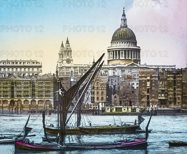 St Paul's cathedral from the Thames with sailing boats near St Paul's Pier.