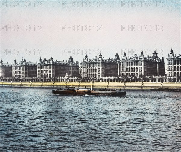 St Thomas Hospital view across the Thames as a pleasure steamer passes.