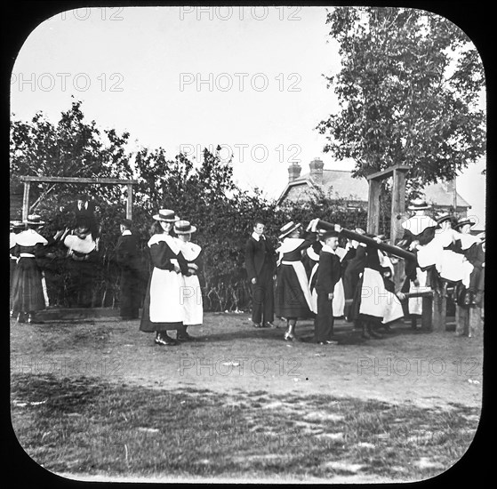 Edwardian children playing in a playground.