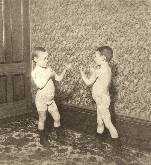 Two children pretending to box.