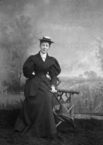 A lady with umbrella with hand painted backdrop.