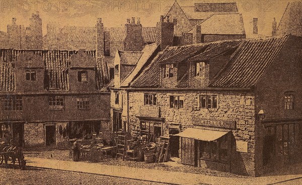 Old cottages in Percy sreet with shops and stalls in street.