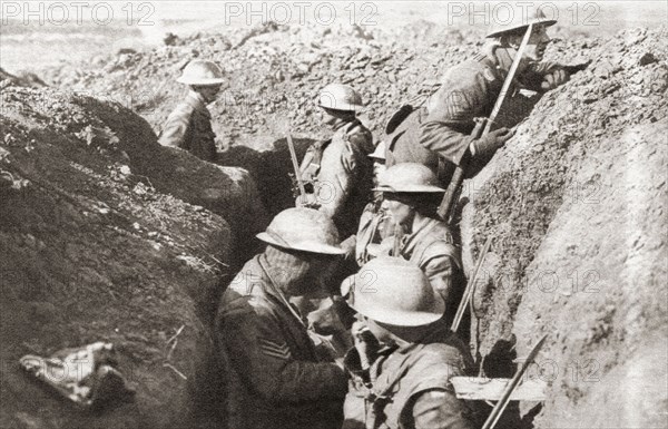Tin-hatted British troops in the front line opposite St. Quentin during the advance in 1917 to the Hindenburg line on the Western Front during WWI.