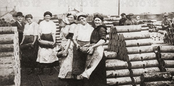 Women packing and loading shell castings during WWI.