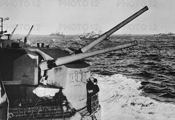 Mr Churchill's battleship the Prince of Wales passing a large convoy in the mid Atlantic.