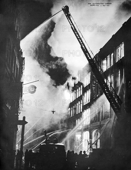 London's fire fighting service directing streams of water from soaring fire ladders and ground vantage points on to a blazing business fire.