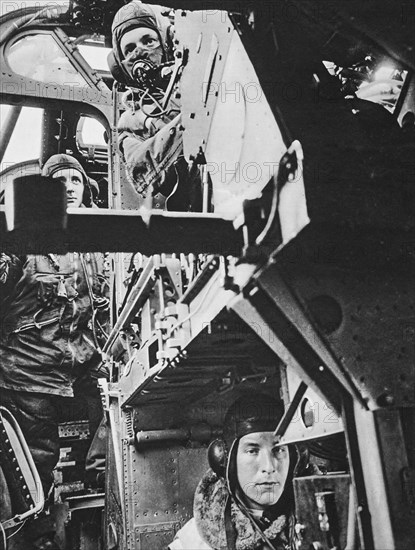 Inside a Halifax bomber, the pilot awaits the signal to take off, behind him is the second pilot and underneath the wireless operator.