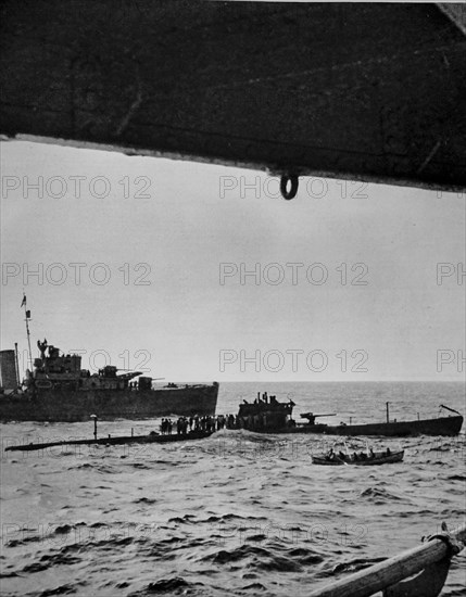 Forced to surface by depth charges Italians lining the deck of a sinking submarine.