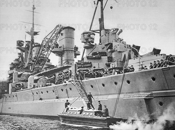 The King spends three days aboard the King George V, his majesty descending the gangway to his barge.