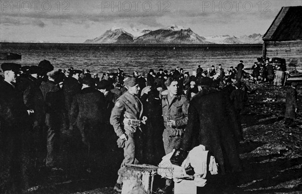 Norwegians waiting to be taken aboard British vessels in the late evening in Spitzbergen.