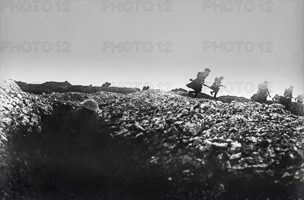 World war 1 troops leaving the trenches and charging with guns.