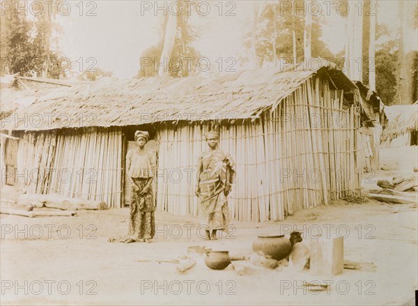 Ghanaian couple outside their hut