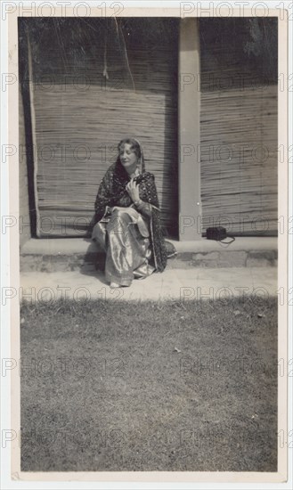 Seated woman in sari during railway outing